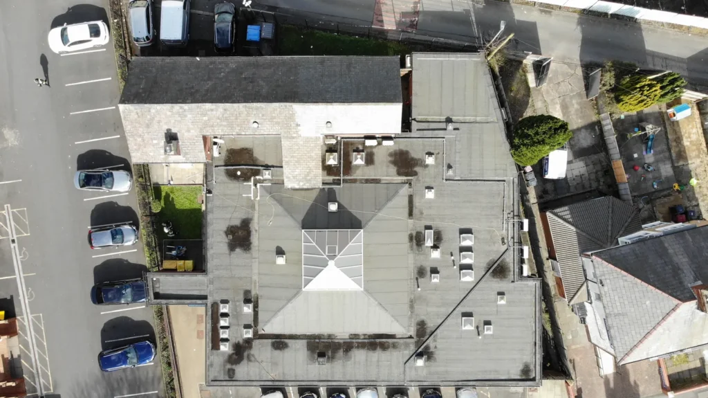 Overhead drone view of a building and its car park
