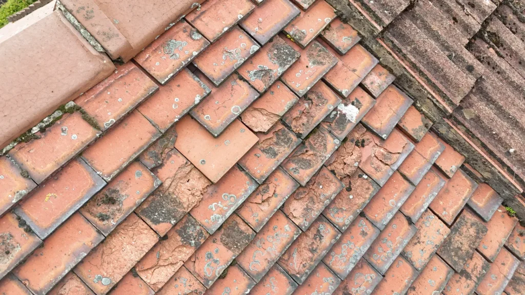 Clay tile roof with cracked and slipped tiles