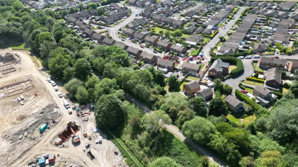 Aerial view of a construction site next to existing housing