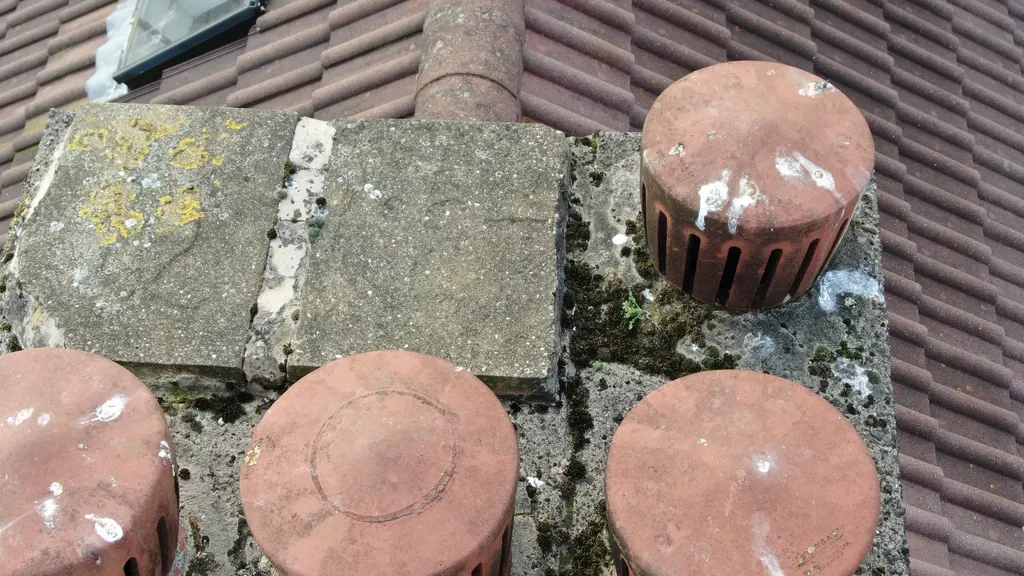 Drone roof survey in Milton Keynes: chimney cowls on a lichen-covered stack