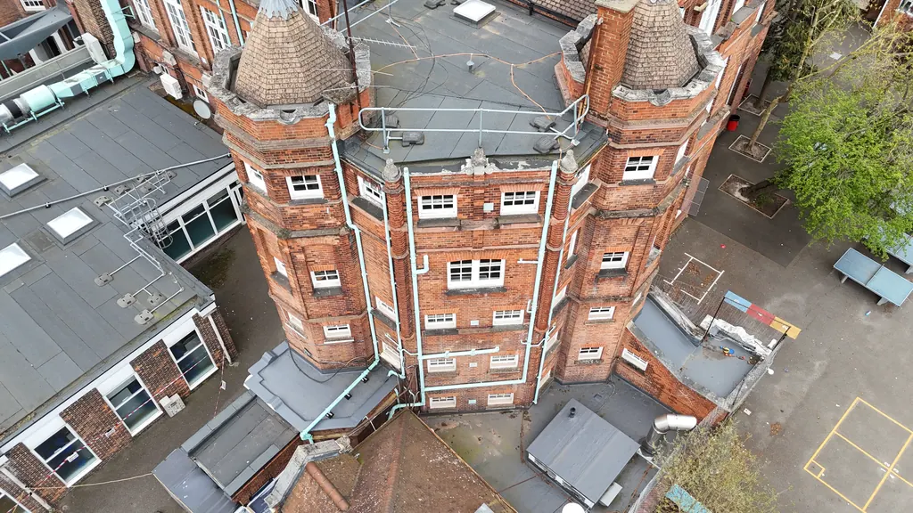 Drone school inspection in Milton Keynes: red-brick school tower and roofs