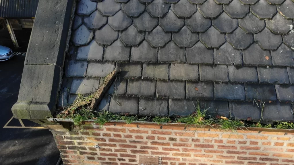 Old and damaged slate roof drone inspection
