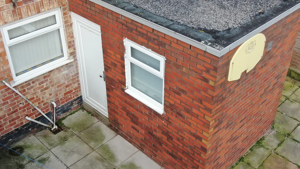 Drone inspection in Swansea: flat-roofed brick outbuilding
