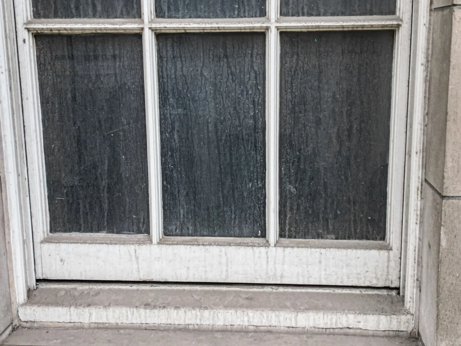 Window frame and stone sill showing weathering